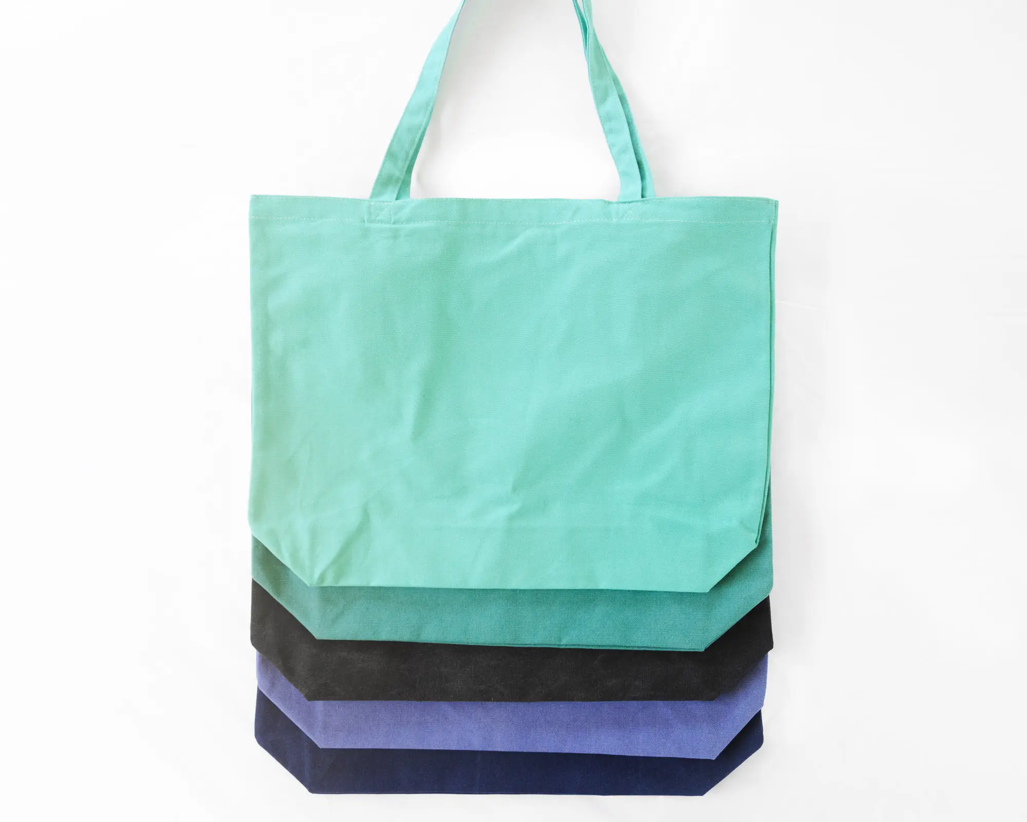 Stack of colorful tote bags.